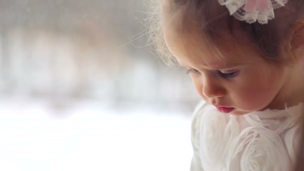 Caucasian, little girl playing at home. A small child playing with toys and books. Little healthy emotional girl. The concept of family happiness, and joy. — Stock Video