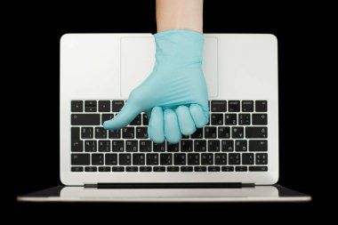 Mavi eldiven, baş parmaklarını gösteriyor. Taşınabilir laptop. Coronavirus koruması. 