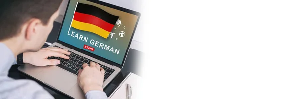 Man working on laptop with LEARN GERMAN on a screen. Education learning german language school concep