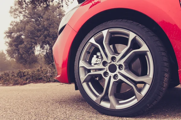 Car wheel on the road — Stock Photo, Image