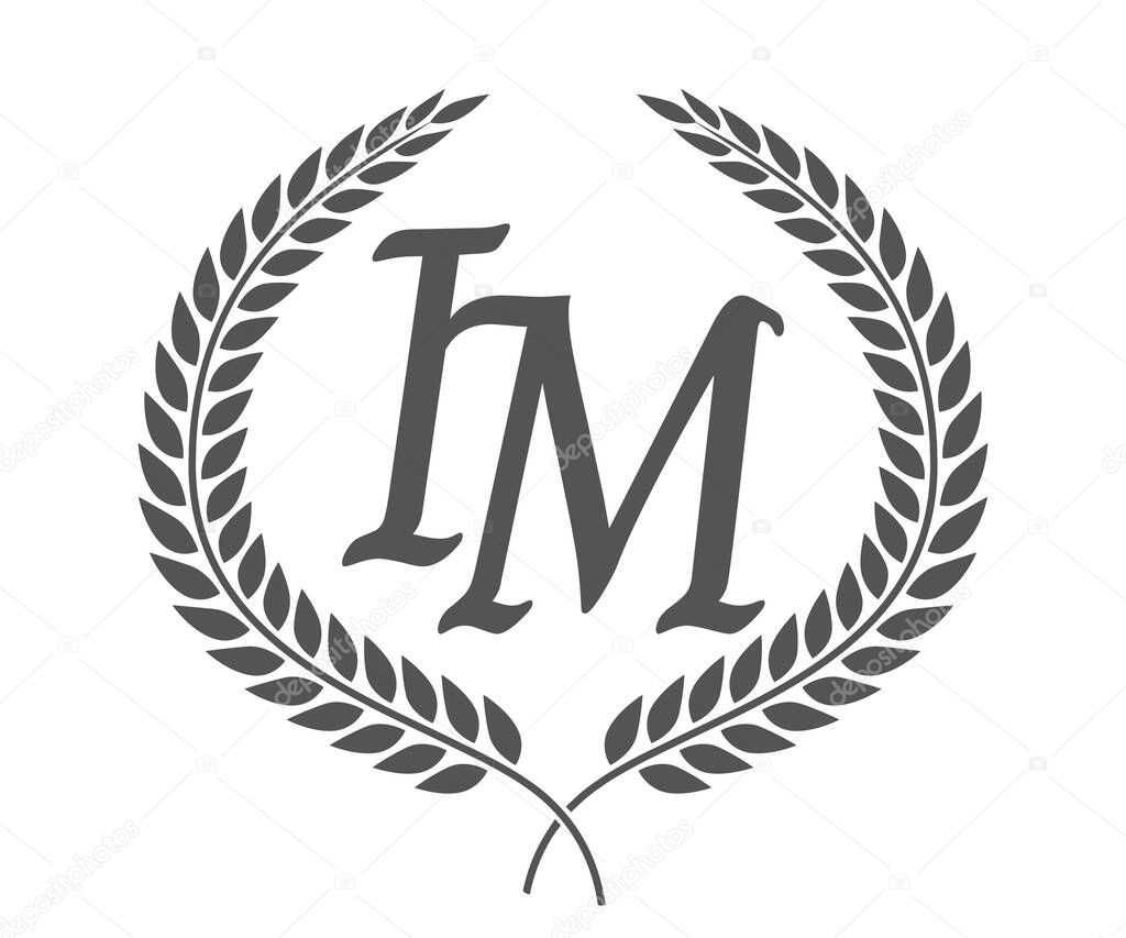 Initial letter I and M, IM monogram logo design with laurel wreath. Luxury emblem with calligraphy font.