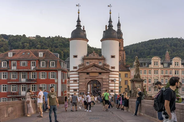 Heidelberg, Alemania - Aug 1, 2020: Los turistas en el puente viejo después del atardecer en verano — Foto de Stock