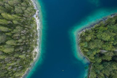 Almanya 'da yaz aylarında Eibseelake tarafındaki ormanların arasından geçen havadan drone görüntüleri.