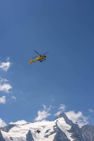 Grossglockner, Austria - Aug 8, 2020: Emergency helicopter rescue ski accident in the mountain