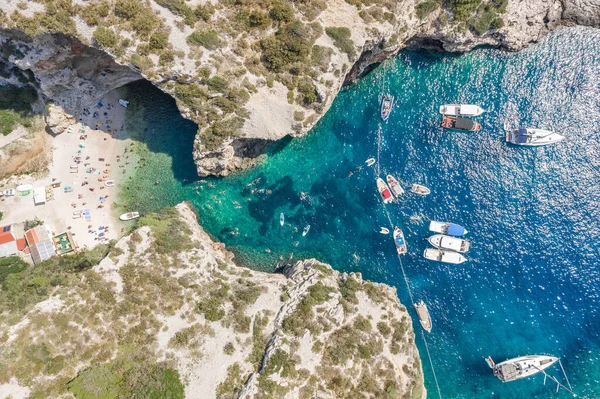 Aerial overhead drone shot of yachts at Stiniva cove Adriatic sea on Vis Island in Croatia summer