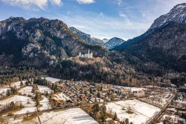 Almanya 'da kış güneşinde karlı tepedeki Neuschwanstein Şatosu' nun insansız hava aracı görüntüleri.