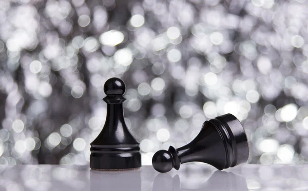 Black Pawns on festive bokeh background — Stock Photo, Image