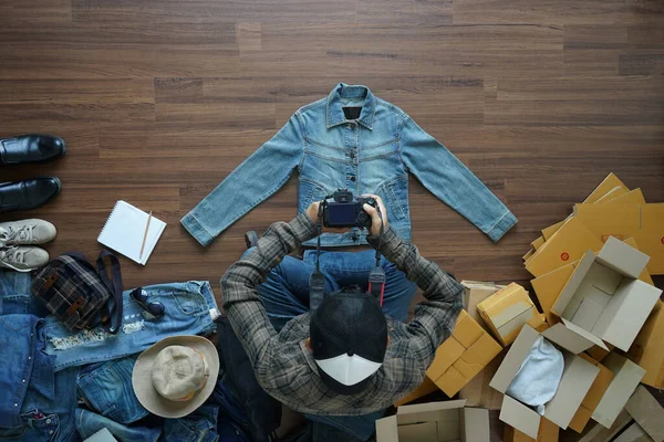 stock image  Top view of men using digital camera shooting take a photo jeans jacket, With fashion accessories on wooden floor with postal parcel, Selling online ideas concept