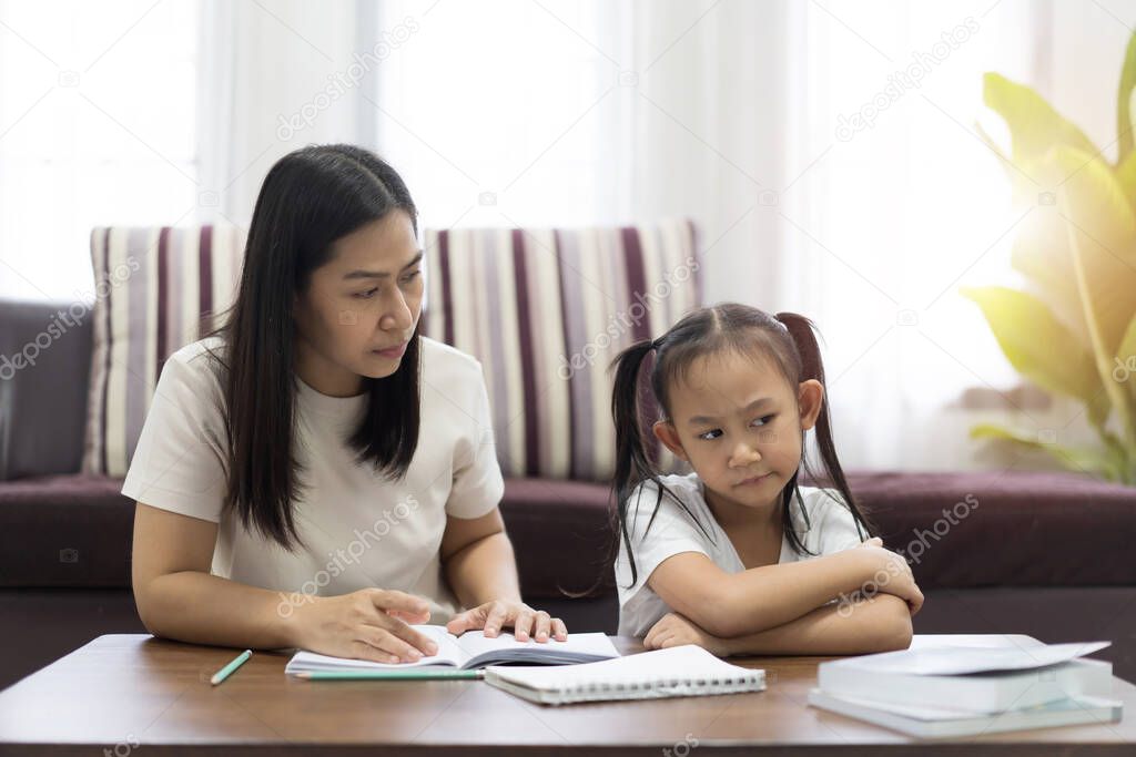 Asian mother and daughter tired and bored teaching homework, Study From Home boring work idea concept 