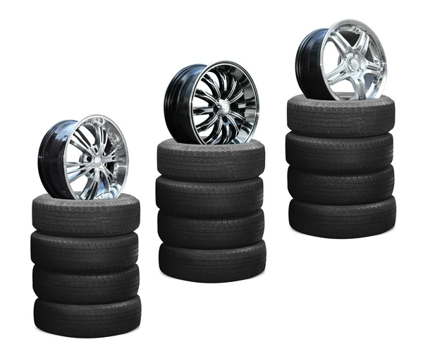 Car alloy wheels on pile tires — Stock Photo, Image