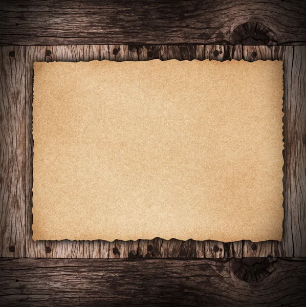 Paper sheet on dark wood — Stock Photo, Image