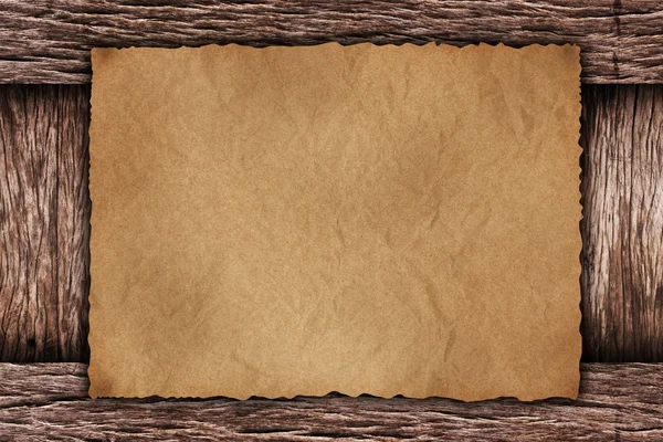 Paper sheet on dark wood — Stock Photo, Image