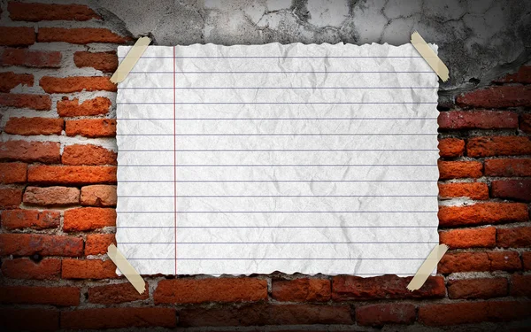 White paper on brick wall — Stock Photo, Image