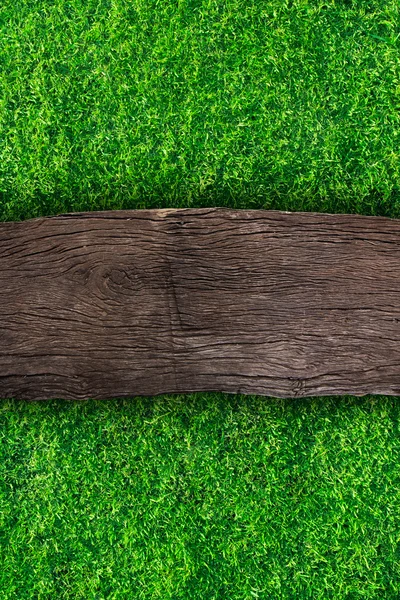 Wooden with green grass background — Stock Photo, Image