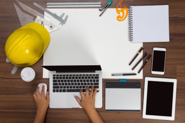 Office desk background hand using a laptop construction project 