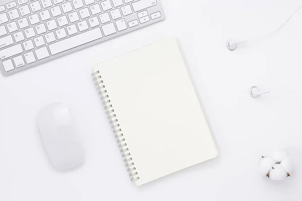 Minimal Office desk table top view with office supply and coffee cup on a white table with copy space, White color workplace composition, flat lay