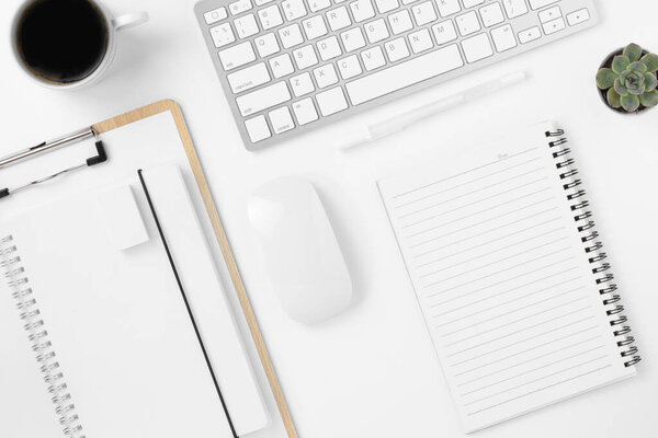 Minimal Office desk table top view with office supply and coffee cup on a white table with copy space, White color workplace composition, flat lay