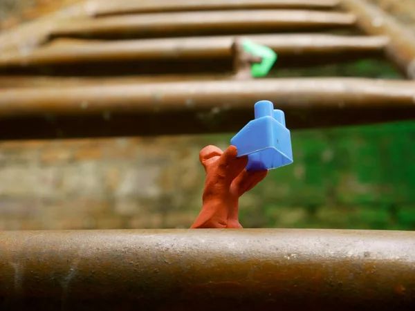 Clay Man Holding Building Block Hand Climbing Iron Metal Stairs — Foto de Stock