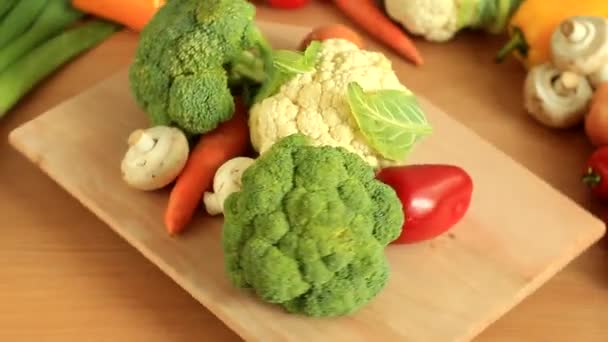 Fresh vegetables on a wooden board rotate — Stock Video