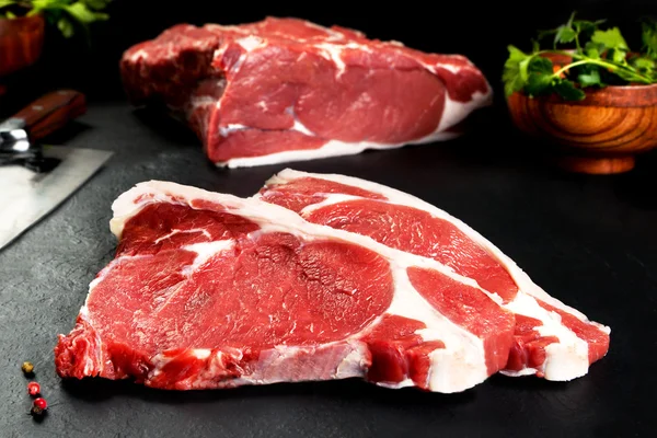 Fresh and raw meat. Ribeye. Uncooked steaks grilled BBQ on black background blackboard — Stock Photo, Image