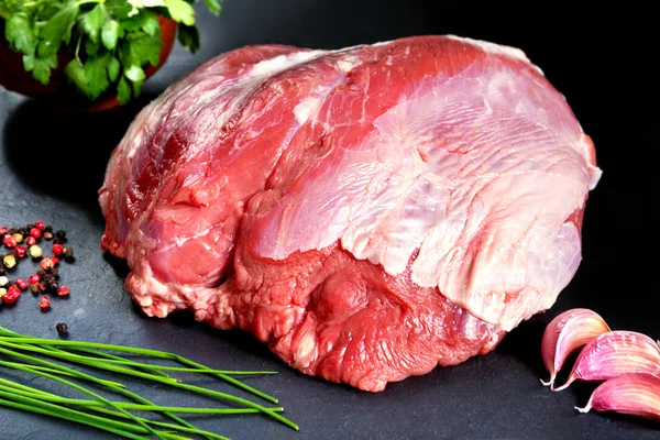 Frisches und rohes Fleisch. ganzes Stück rotes Fleisch fertig zum Kochen auf dem Grill oder Grill. Hintergrund schwarze Tafel — Stockfoto