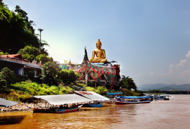 Golden Buddha on the Mekong River, Sop Ruak, Thailand. Gorgeous Asian landscape clipart