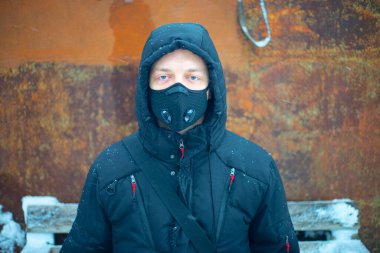 Şiddetli kar yağışı sırasında maske takan adam.