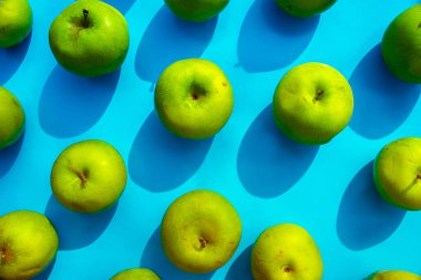 mavi arkaplanda yeşil elma, meyveler