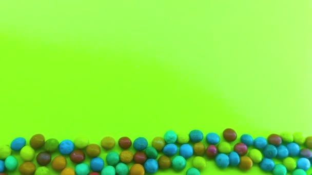 Background Many Multicolored Candies Chocolates Glaze Green Background — Stock Video