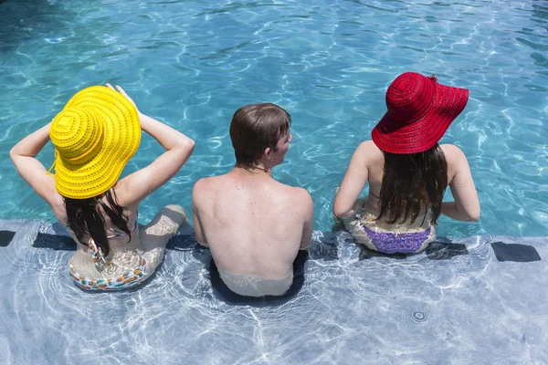 Dziewczyny kapelusze chłopiec basen letni — Zdjęcie stockowe