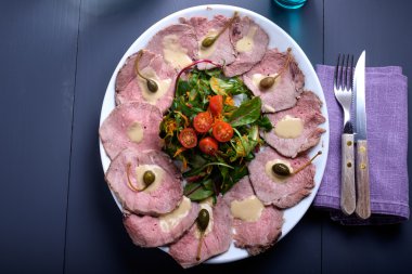 vitello tonnato on a serving plate with water clipart