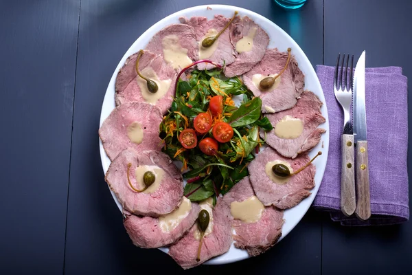 Vitello tonnato on a serving plate with water — Stock Photo, Image