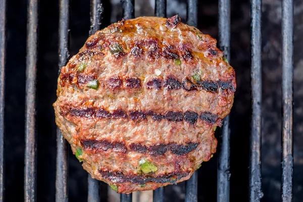 Hamburgers on the grill with stripes outdoors — Stock Photo, Image