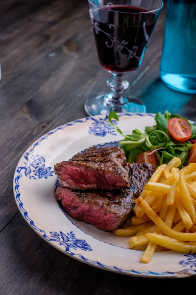 Steak dinner with fries and sauce on the side — Stock Photo, Image
