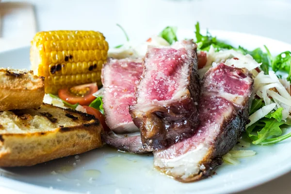 Mixed grill steak with corn and bread — Stock Photo, Image
