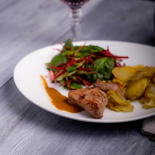 Veal steak with sauce and potatoes — Stock Photo, Image