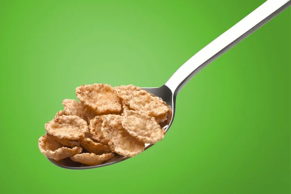 Corn flakes in a metal spoon — Stock Photo, Image