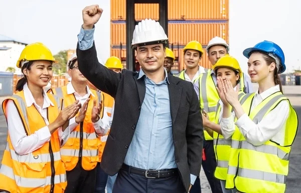 Professional Engineering and worker team congratulated success by applaud their leader after construction project complete and he Raise your hand happily