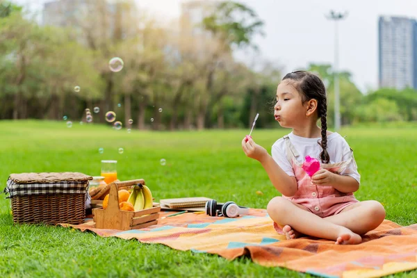 Happy Little Girl Kid Blowing Soap Bubbles Playing Alone Park — Stock Photo, Image