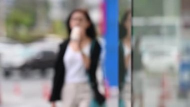 Genç Asyalı güzel iş kadını mağazada yürüyor.