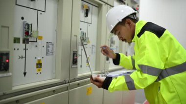 Mühendis bilgisayar işçisi büyük makineleri kontrol ediyor
