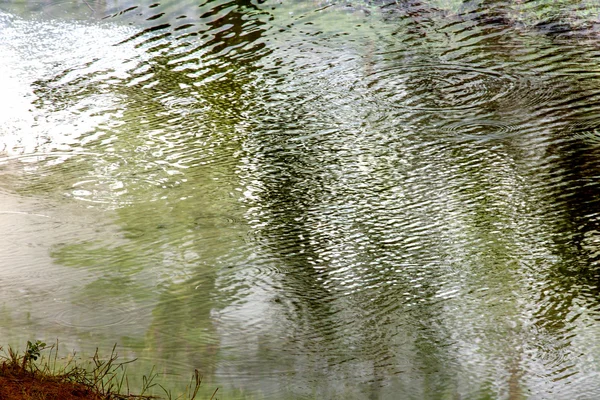 Gota chuvosa e ondas na água — Fotografia de Stock