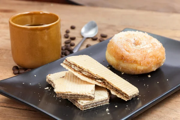coffee and wafer stick and donuts sugar