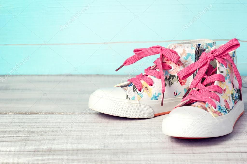 Textile lace sneakers shoes background empty space.