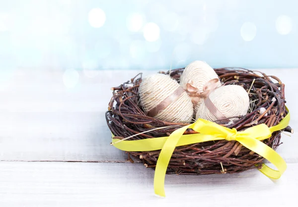 Easter eggs in nest wooden background empty space for text. — Stock Photo, Image