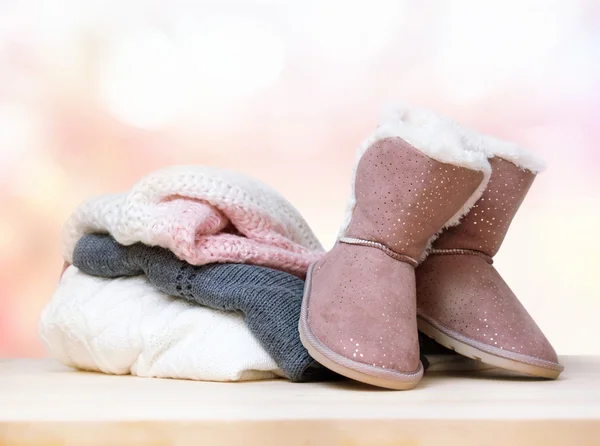 Pair of winter shoes uggs knitted clothes. — Stock Photo, Image