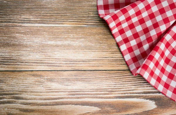 Red picnic cloth on wooden background.Napkin tablecloth on old w — Stock Photo, Image
