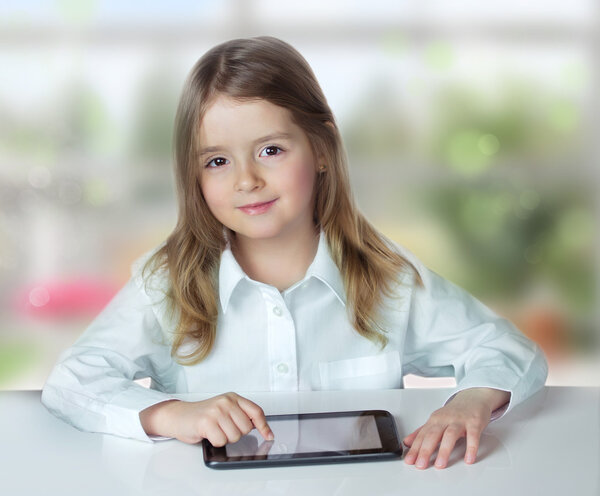 Child girl laptop tablet ipad sit table indoor.