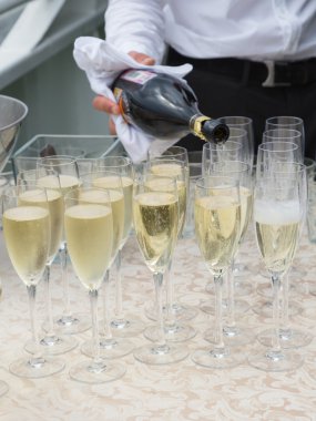 Garson kadehlere şampanya dolduruyor.