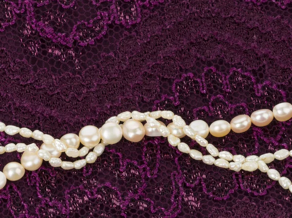 Pearl beads on a lace cloth — Stock Photo, Image